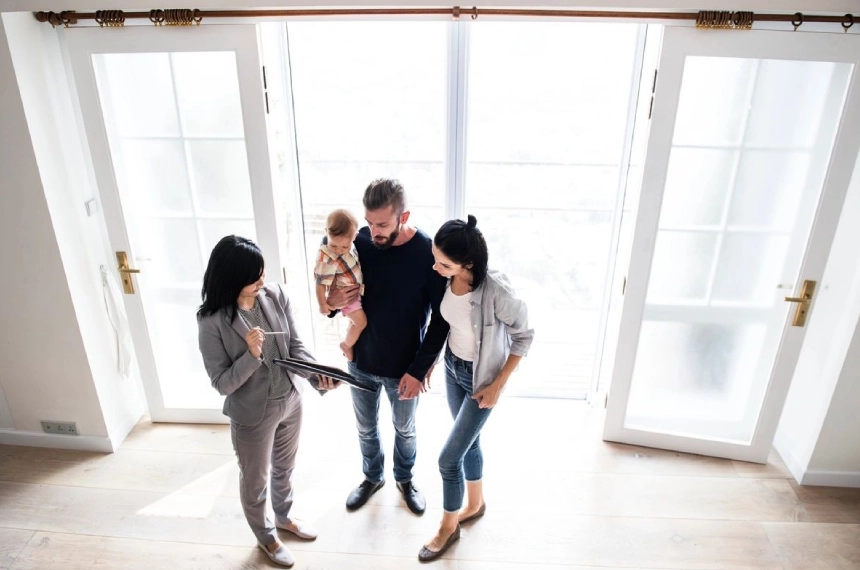 A group of people standing in front of a window.